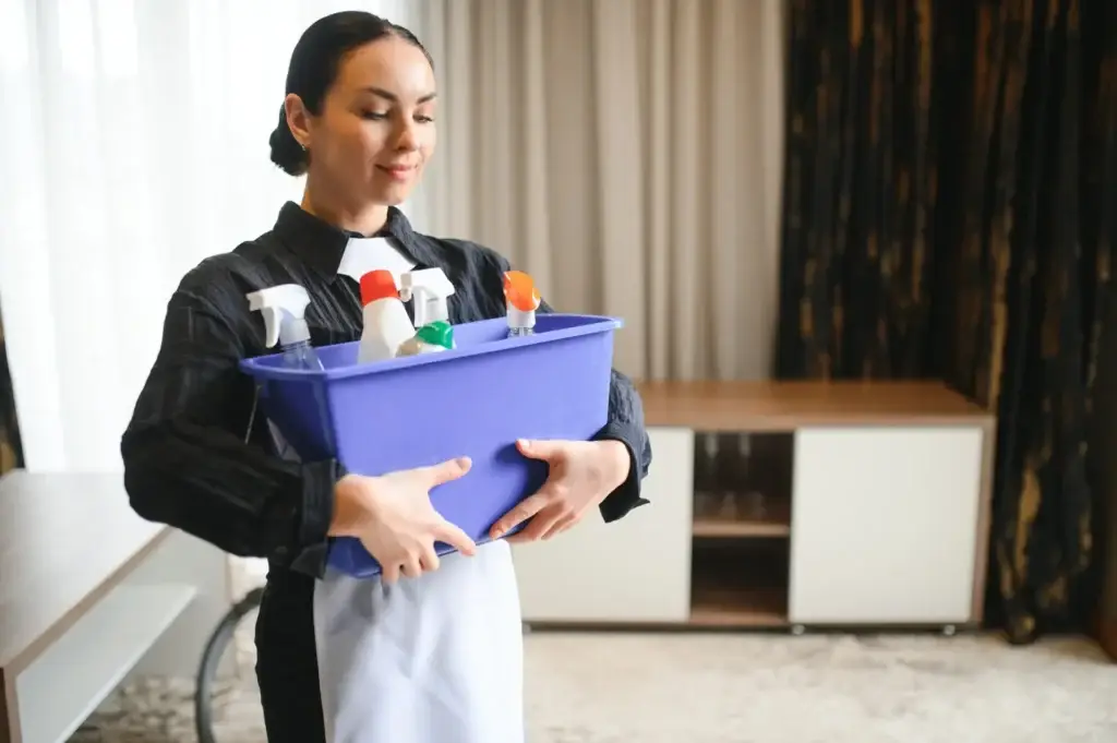 Housekeeper or Maid cleaning hotel room