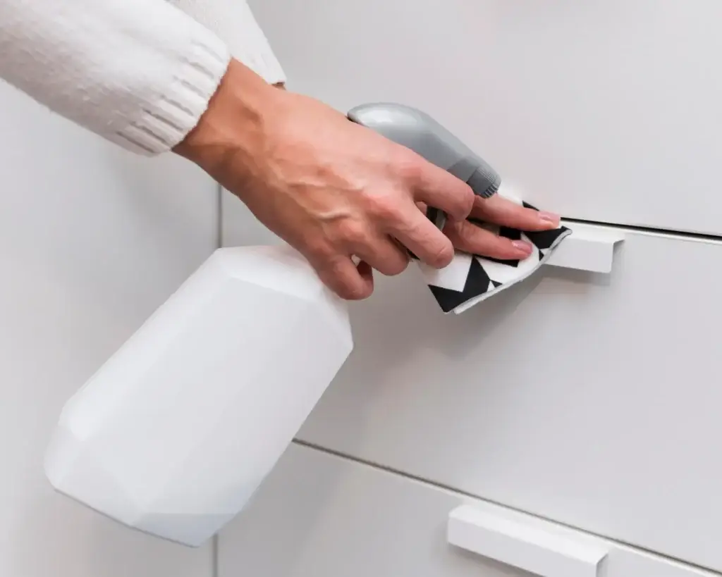 Clean metal handles on kitchen cabinets