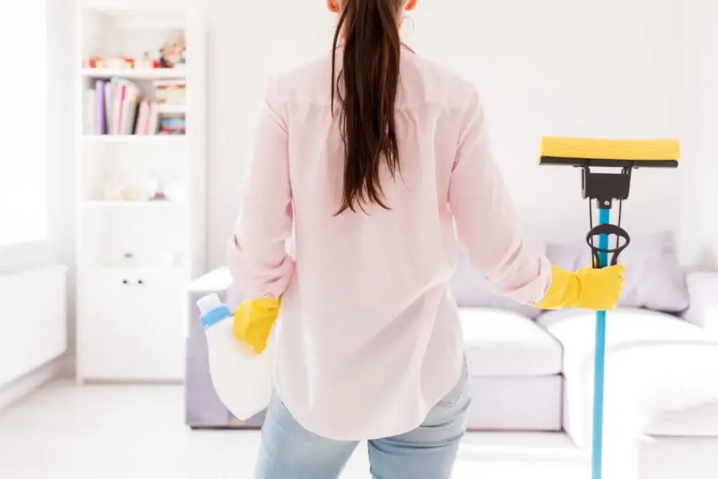 Woman cleaning illustrating the health benefits of a clean home.