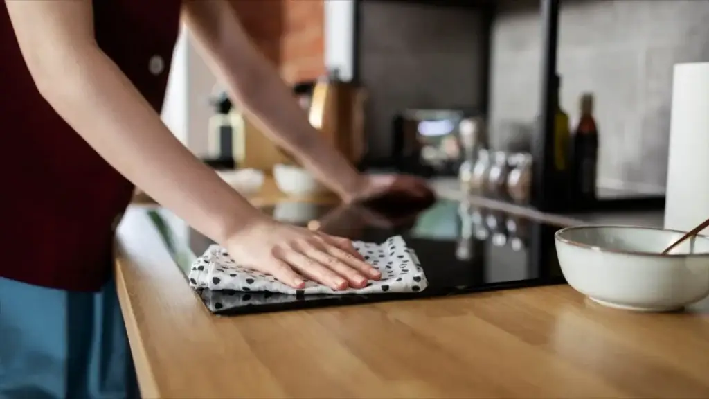 hand wiping kitchen countertop