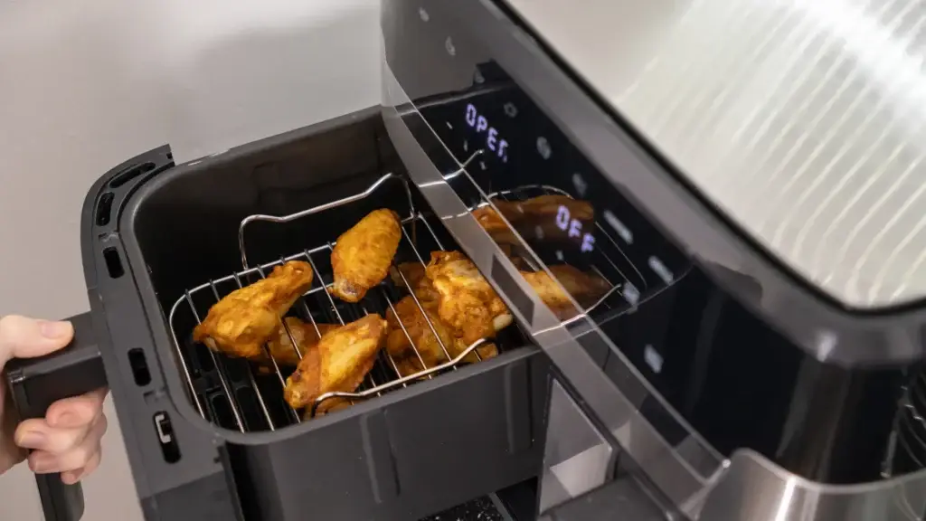 Crispy chicken wings in open air fryer basket