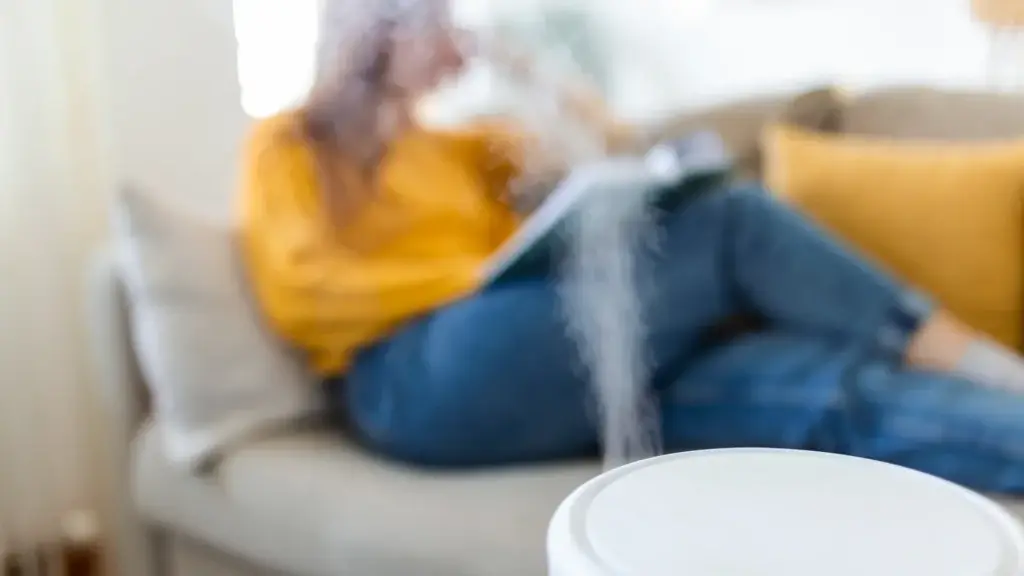 Air purifier releasing mist in a cozy living room